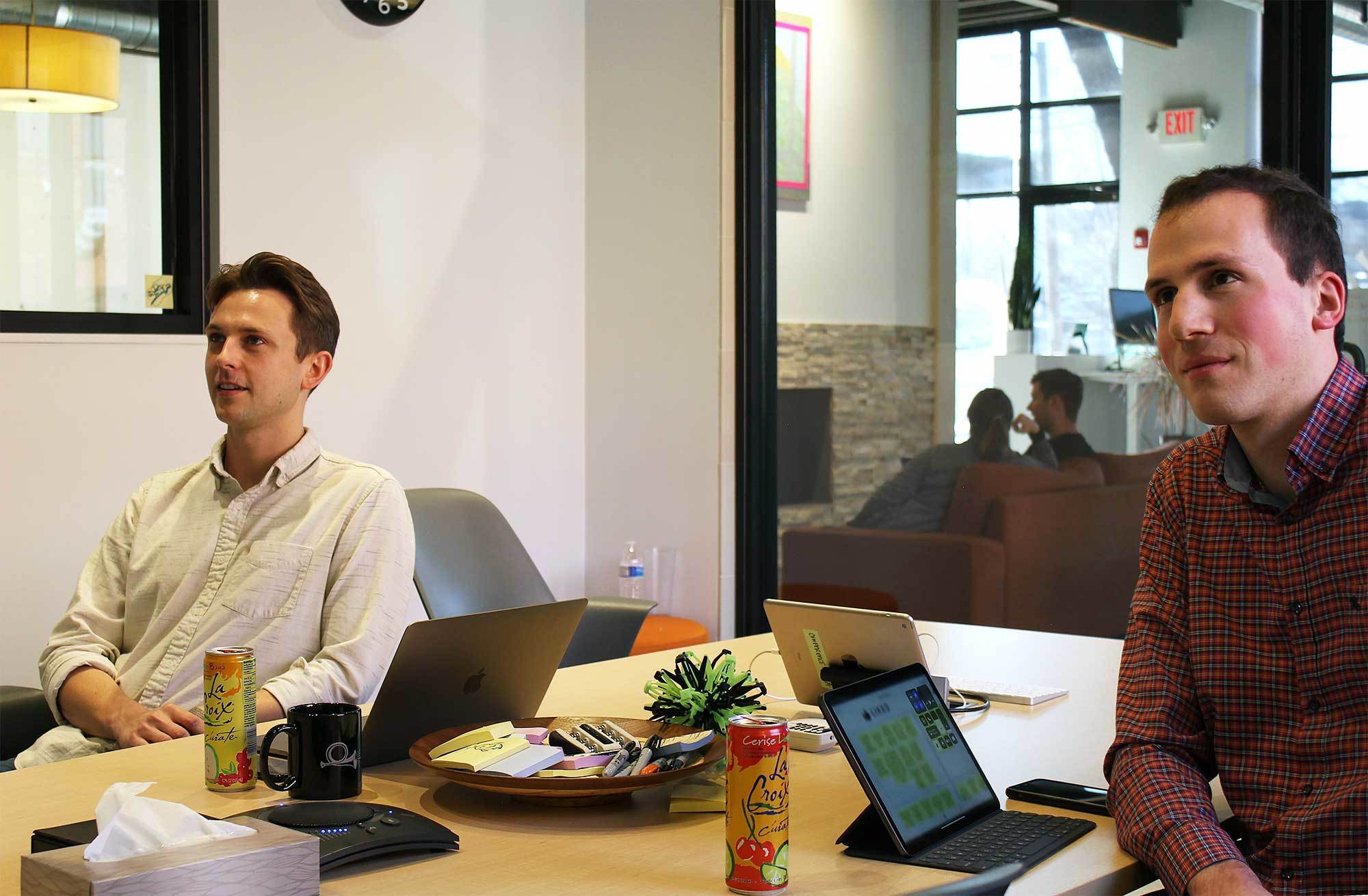 A Photo of Michael and Crema's Director of Project Management,Tucker, in a meeting